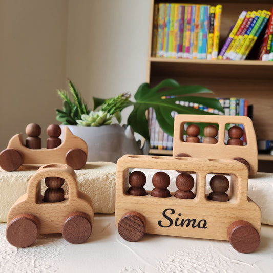 Wooden puzzle toy with wooden balls on a white surface, books and plant in the background