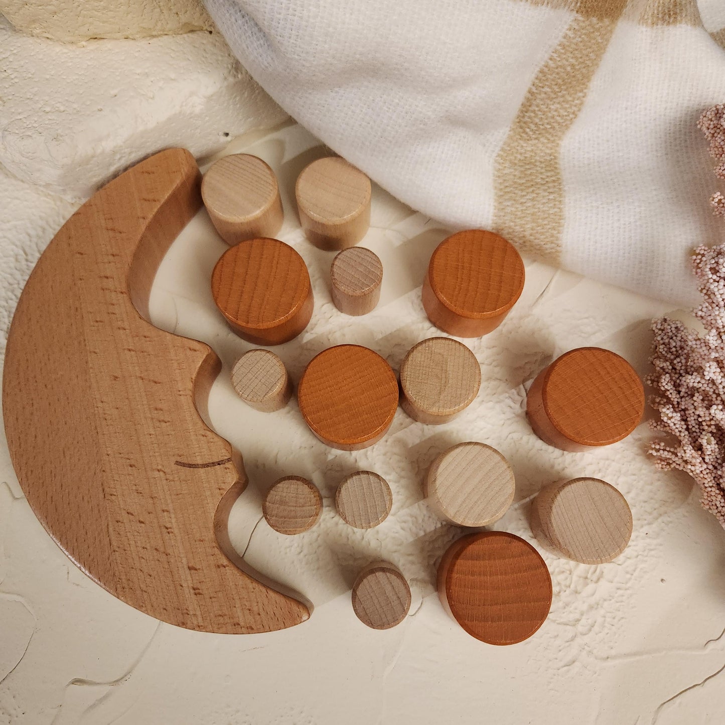Montessori wooden moon balancing toy in natural wood tones, beautifully displayed on a table – smooth, handcrafted educational toy that encourages fine motor skills and open-ended play for toddlers.