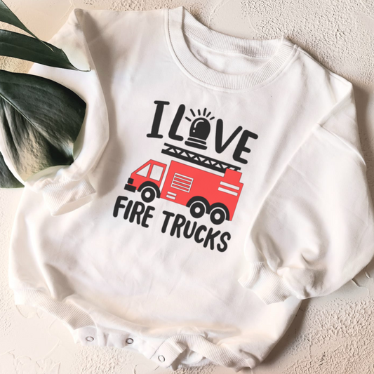 White baby onesie with 'I Love Fire Trucks' text and fire truck graphic on a light background