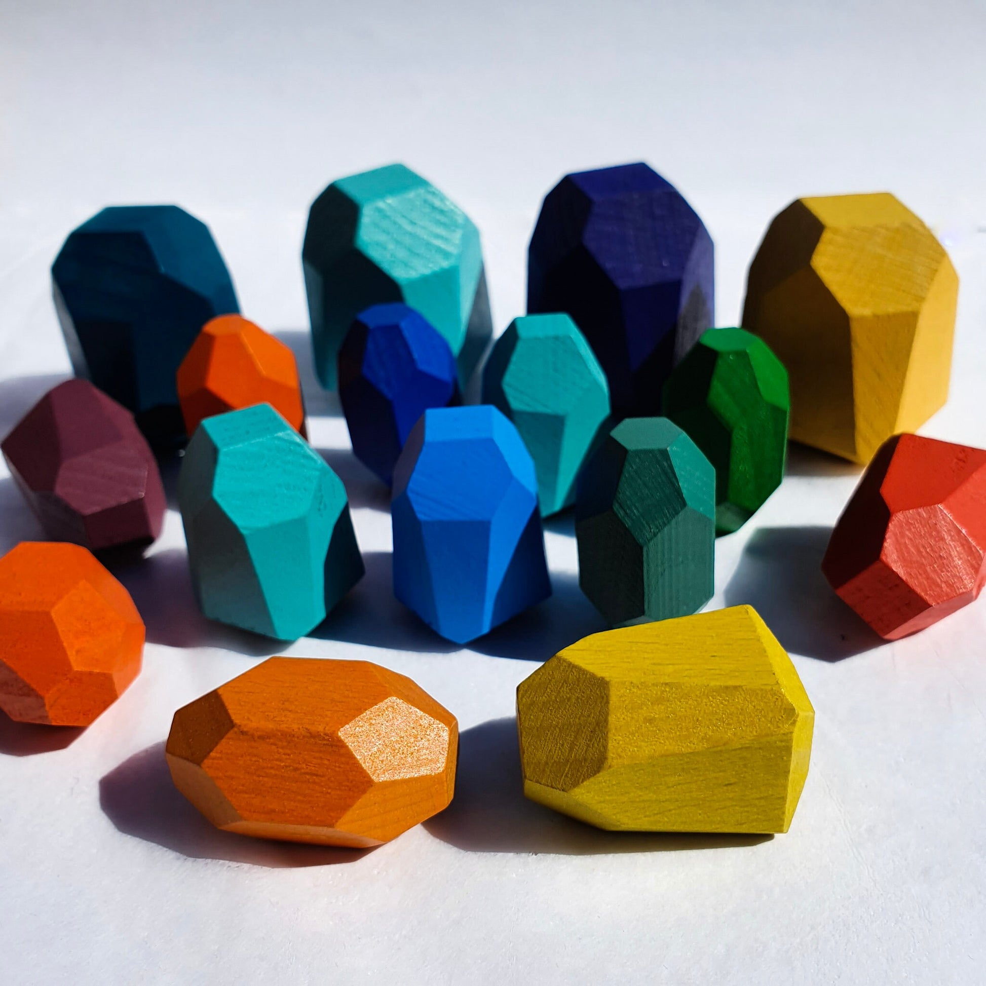 Colorful wooden balancing rocks showing different shapes and sizes