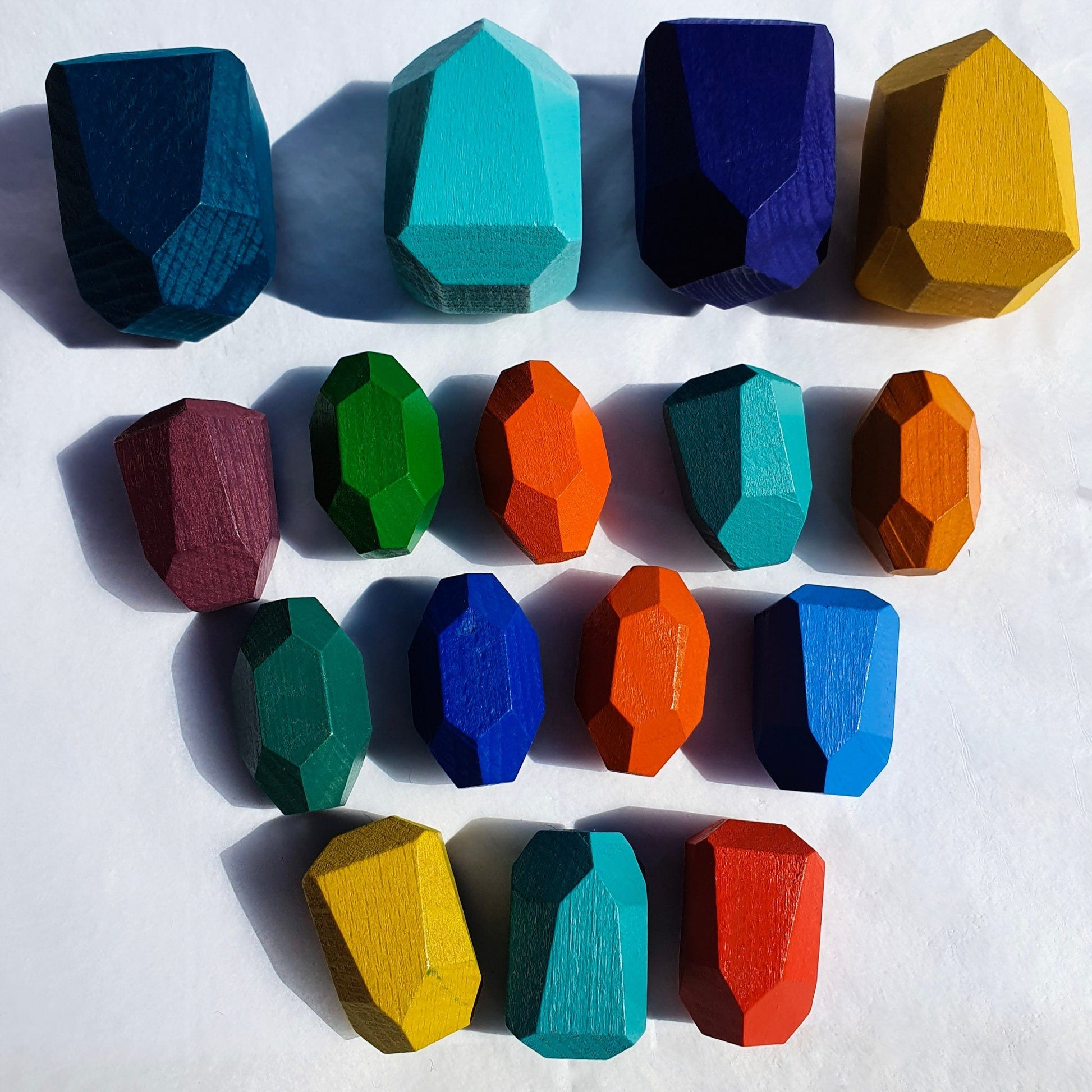 Colorful wooden balancing rocks showing different shapes and sizes