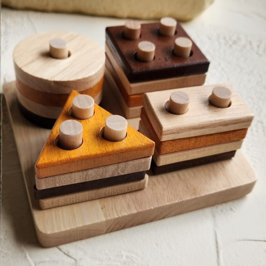Set of wooden shape sorting toys on a light surface