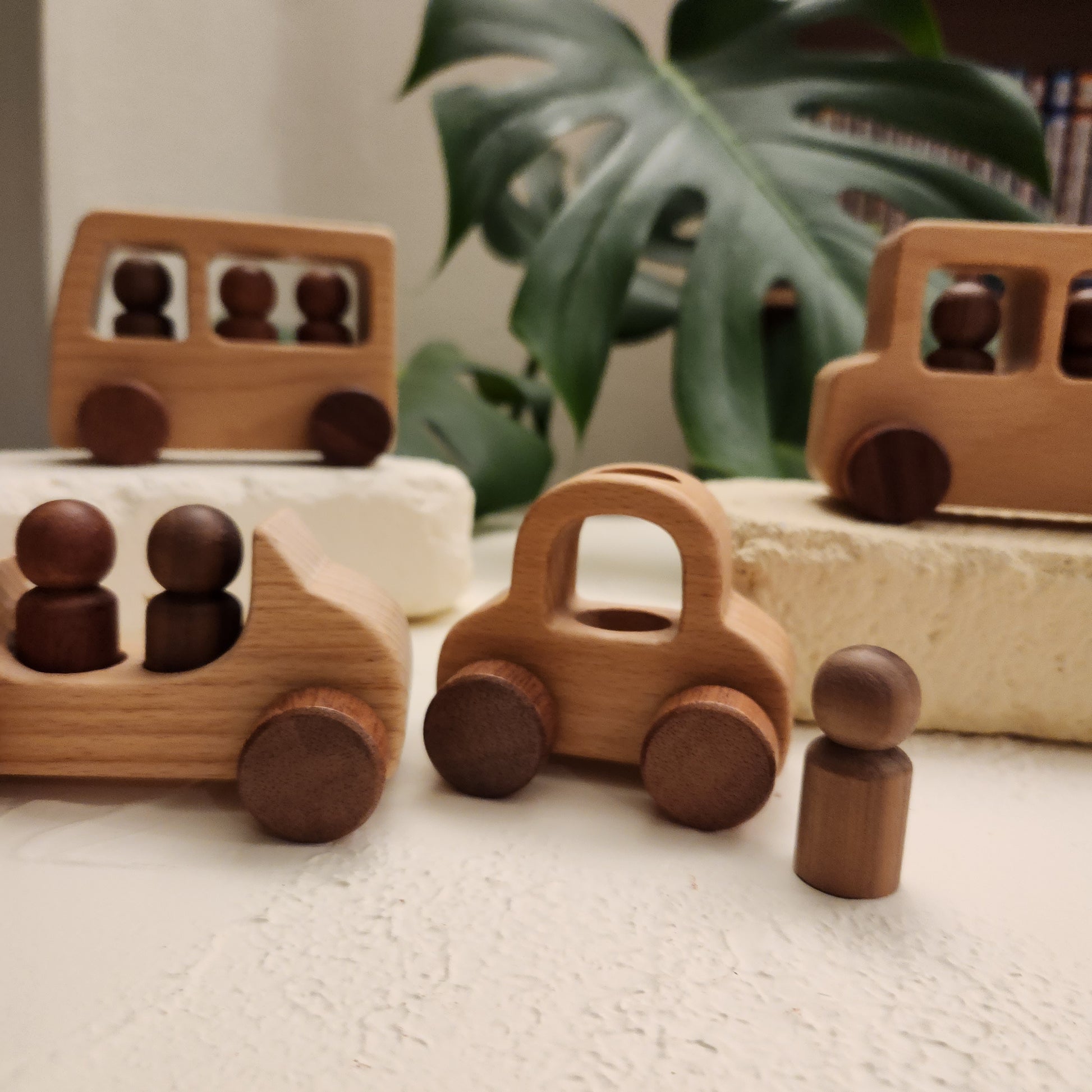 Close-up of wooden toy car with peg people showing natural beech wood finish