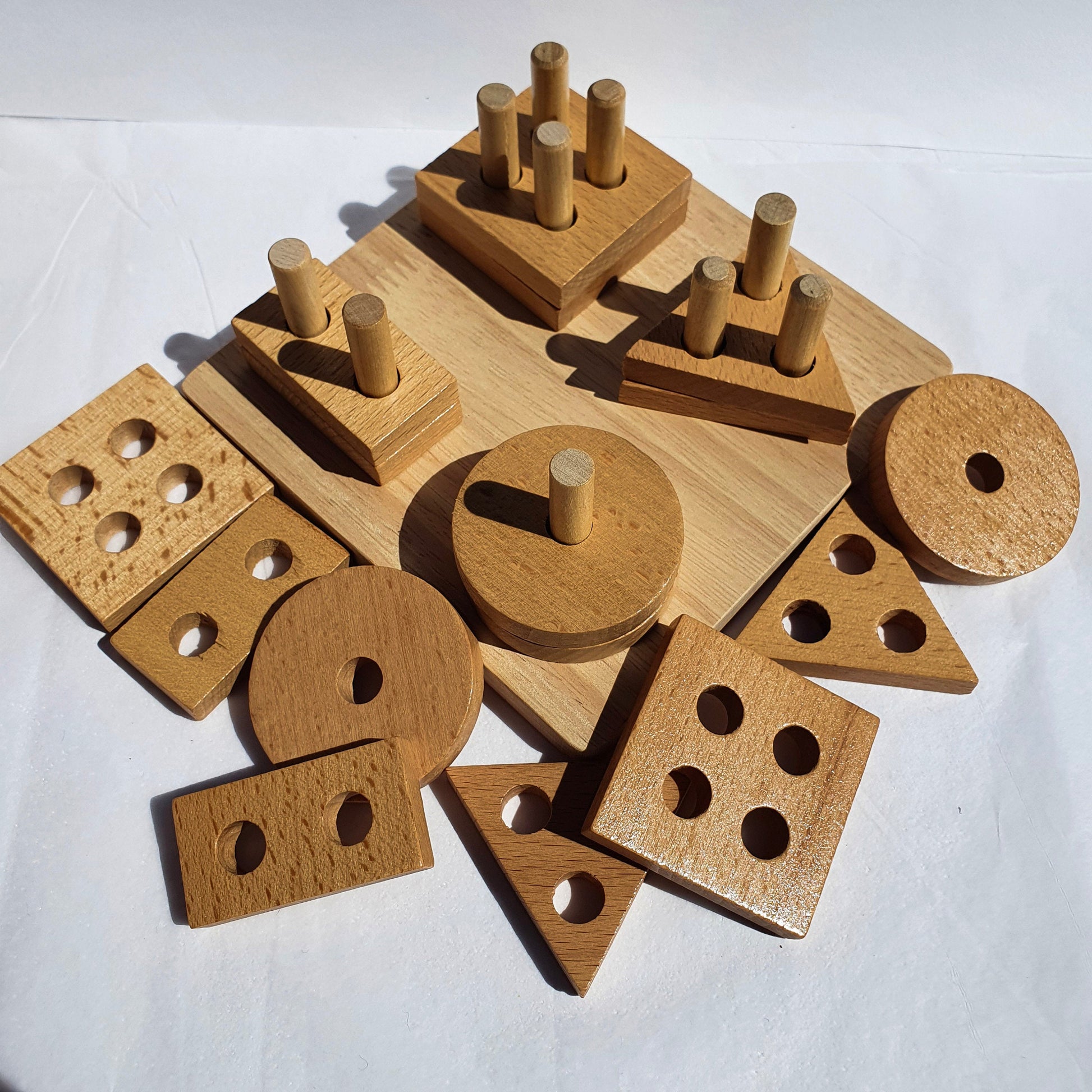 Wooden geometric shape sorter with natural color of circles triangles squares rectangles