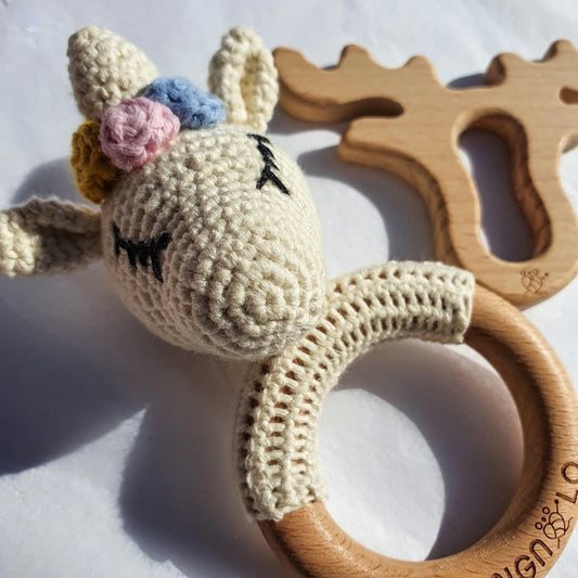 Crochet unicorn baby toy with wooden component for teething