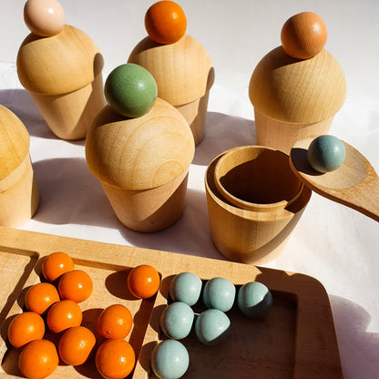 Montessori marble sorting activity showing fine motor skill development